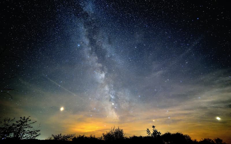 Can you see stars in space? Why are many space photos black against a background?