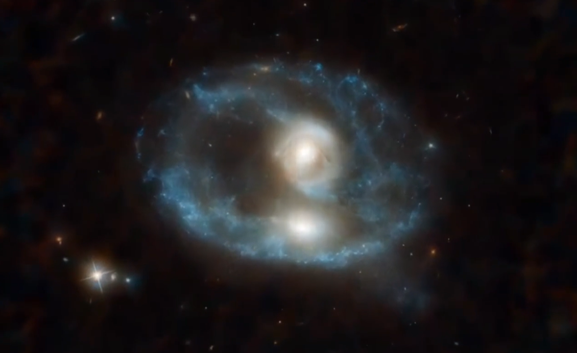 What is the "Grimace" Galaxy? The mystery of a cosmic "ghostly face" and a galactic collision 700 million light-years away.